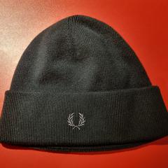 Black hat Fred Perry, as reported by MEININGER Hotel Amsterdam City West using iLost